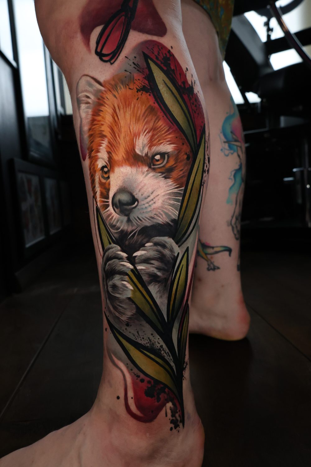 Red panda and bamboo neo-traditional tattoo by Kimmi Gayle