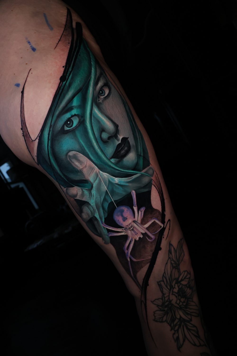 Teal portrait and spider surrealism calf tattoo by Kimmi Gayle